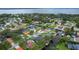 Aerial view of a waterfront home with dock access, situated in a community with lush landscaping and water access at 1620 Texas Ct, Tavares, FL 32778