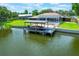 Aerial view of the pool, screened-in patio, and covered boat dock at 1620 Texas Ct, Tavares, FL 32778