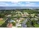 Aerial view of a property with a pool, dock, waterfront access and well-maintained landscaping at 1620 Texas Ct, Tavares, FL 32778