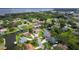 A scenic aerial view of a waterfront neighborhood featuring charming homes with boat docks and canal access at 1620 Texas Ct, Tavares, FL 32778