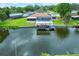 Aerial view of the pool, screened-in patio, and covered boat dock on canal at 1620 Texas Ct, Tavares, FL 32778