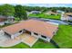 Stunning aerial view of the house showcasing its roof, surrounding lawns, and canal front location at 1620 Texas Ct, Tavares, FL 32778