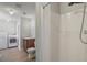 Bright bathroom with shower, sink, toilet, washer, and dryer at 1620 Texas Ct, Tavares, FL 32778