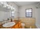Updated bathroom with granite countertops, ample lighting, and a window at 1620 Texas Ct, Tavares, FL 32778