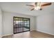 Bedroom with wood floors and sliding glass doors to the porch with a ceiling fan at 1620 Texas Ct, Tavares, FL 32778