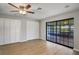 Bright bedroom featuring wood floors, a ceiling fan, and sliding glass doors to the porch at 1620 Texas Ct, Tavares, FL 32778