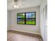 Cozy bedroom featuring a window with a view, wood floors, and a closet at 1620 Texas Ct, Tavares, FL 32778