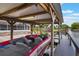 Covered boat dock with a red motorboat with seats and steering wheel at 1620 Texas Ct, Tavares, FL 32778