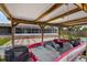 Covered boat dock with a red motorboat with seats and an outboard engine at 1620 Texas Ct, Tavares, FL 32778