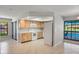 Bright kitchen with natural wood cabinets and views of the pool at 1620 Texas Ct, Tavares, FL 32778