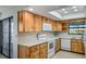 Kitchen with light wood cabinets and white countertops and appliances at 1620 Texas Ct, Tavares, FL 32778