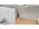 View of laundry room area off kitchen with white refrigerator at 1620 Texas Ct, Tavares, FL 32778