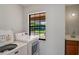 Bright laundry area with a washing machine, dryer, window, and sink at 1620 Texas Ct, Tavares, FL 32778