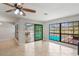 Open living room with tile flooring and large sliding doors leading to the pool area at 1620 Texas Ct, Tavares, FL 32778