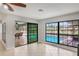 Open living room with tile floors, ceiling fan and sliding glass doors leading to pool at 1620 Texas Ct, Tavares, FL 32778