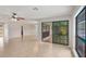 Spacious living room with tile flooring and sliding glass doors leading to pool area at 1620 Texas Ct, Tavares, FL 32778
