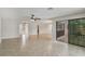 Open living room with tile flooring and large sliding doors leading to pool at 1620 Texas Ct, Tavares, FL 32778