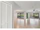 Spacious living room with tile flooring, ceiling fan and sliding glass doors to the pool area at 1620 Texas Ct, Tavares, FL 32778