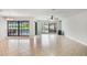 Open living room with tile flooring, ceiling fan and large windows to the pool at 1620 Texas Ct, Tavares, FL 32778