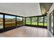 Enclosed lanai with vinyl floors overlooking the manicured lawn at 1620 Texas Ct, Tavares, FL 32778