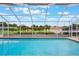 Spacious screened-in pool with views of the lush backyard, offering a private oasis at 1620 Texas Ct, Tavares, FL 32778
