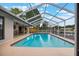 Inviting screened-in pool area with outdoor dining, overlooking a tranquil backyard setting at 1620 Texas Ct, Tavares, FL 32778