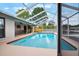 Relaxing screened-in pool with a backyard view, great for cooling off on warm days at 1620 Texas Ct, Tavares, FL 32778