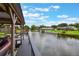 View of the waterfront canal with covered boat dock and gray wood pier at 1620 Texas Ct, Tavares, FL 32778
