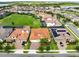 Aerial view of a residential neighborhood with red-tiled roofs and green spaces at 16696 Otterchase Ln, Winter Garden, FL 34787
