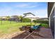 Spacious backyard with lush lawn, brick patio, and neatly trimmed hedges at 16696 Otterchase Ln, Winter Garden, FL 34787
