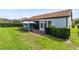 Wide backyard view with brick patio, outdoor seating, and privacy hedges at 16696 Otterchase Ln, Winter Garden, FL 34787
