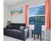 Comfortable bedroom with a futon, desk, and window at 16696 Otterchase Ln, Winter Garden, FL 34787
