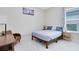Cozy bedroom features a comfortable bed, a side table, and natural light from a window at 16696 Otterchase Ln, Winter Garden, FL 34787