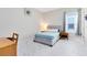 Bedroom features a bed, side table, and natural light from the window at 16696 Otterchase Ln, Winter Garden, FL 34787