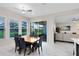 Bright dining area features tile floors, access to the outdoor lanai and open floorplan at 16696 Otterchase Ln, Winter Garden, FL 34787