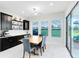 Bright dining area features large windows and a sliding glass door to the lanai at 16696 Otterchase Ln, Winter Garden, FL 34787