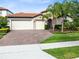 Beautiful home exterior featuring a well-manicured lawn and an elegant brick driveway at 16696 Otterchase Ln, Winter Garden, FL 34787