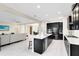 Open-concept kitchen featuring a large island with seating that connects to living and dining areas at 16696 Otterchase Ln, Winter Garden, FL 34787