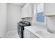 Bright laundry room featuring modern washer and dryer, sink and ample white cabinet storage at 16696 Otterchase Ln, Winter Garden, FL 34787