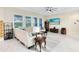 Bright living room featuring tile floors, neutral walls, sectional sofa, and large windows at 16696 Otterchase Ln, Winter Garden, FL 34787