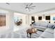 A living room featuring an open-concept design, seamlessly connecting to the dining and kitchen areas at 16696 Otterchase Ln, Winter Garden, FL 34787