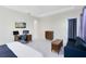 Spacious main bedroom includes a desk and media area in addition to the bed at 16696 Otterchase Ln, Winter Garden, FL 34787