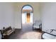 View of the home's entrance with arched entryway and seating area, perfect for guests at 16696 Otterchase Ln, Winter Garden, FL 34787