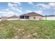 Expansive backyard view featuring green grass, a shed, and a fenced perimeter at 186 Nw 44Th St, Ocala, FL 34475
