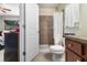 This three-quarter bathroom features a single sink vanity, and a shower with brown tiled walls at 186 Nw 44Th St, Ocala, FL 34475