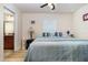 Cozy bedroom with wood floors, window, and doorway to ensuite bathroom at 186 Nw 44Th St, Ocala, FL 34475