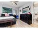 Cozy bedroom with wood floors, a large mirror, and ensuite bathroom at 186 Nw 44Th St, Ocala, FL 34475