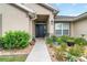 Inviting front entrance with a black door, attractive landscaping, and a walkway leading to the home at 186 Nw 44Th St, Ocala, FL 34475