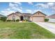 Charming single-story home featuring a well-maintained lawn, landscaping and an attached two car garage at 186 Nw 44Th St, Ocala, FL 34475
