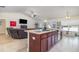 Open kitchen with a granite island, stainless appliances, seamlessly blending with the living area and TV at 186 Nw 44Th St, Ocala, FL 34475